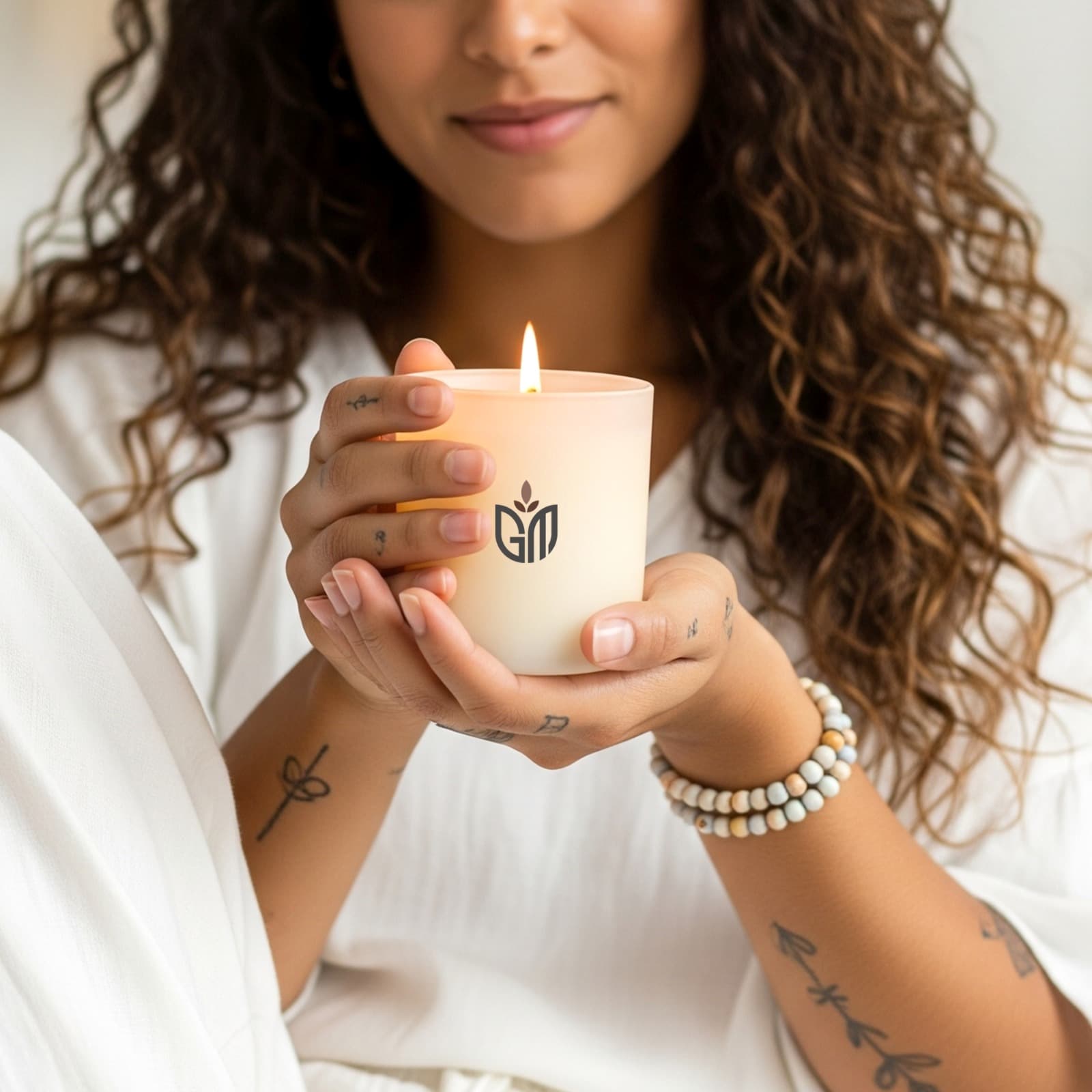 Woman holding GOOD signature candle